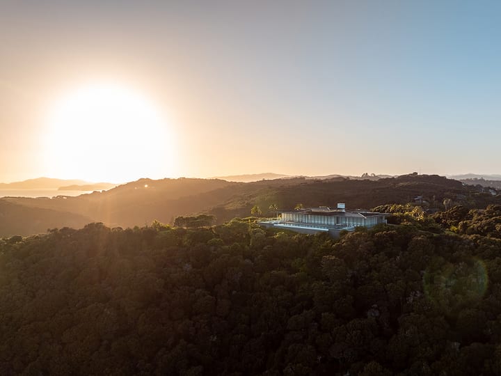 Aerial view of lodge amid dense bush at sunset