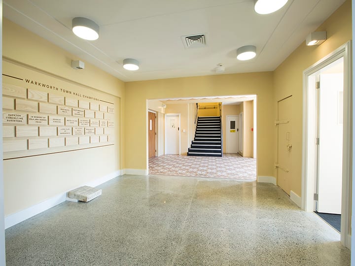 Hall foyer with polished concrete floor, honour boards and staircase