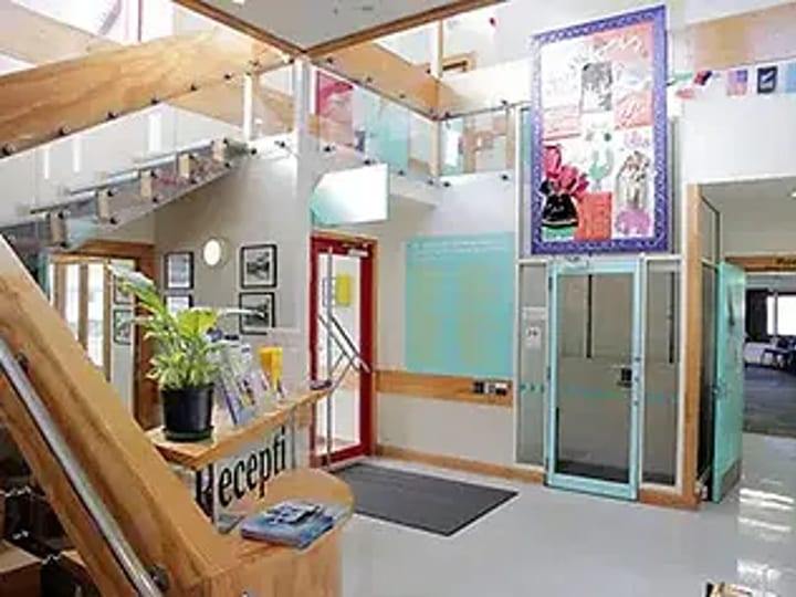 Community centre reception foyer with stairs and lift
