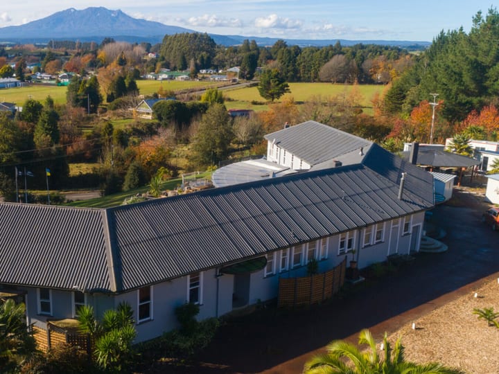 Aerial view of lodge roof and grounds with mountain visible in background