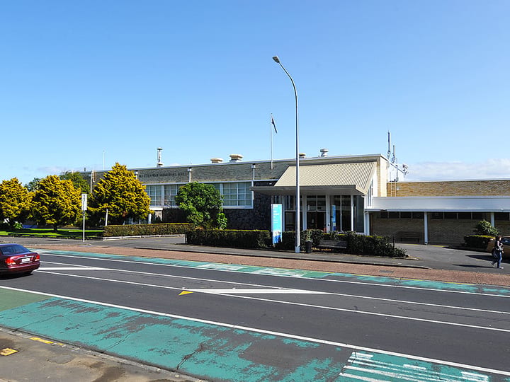 Civic hall building viewed from across the road with flagpole
