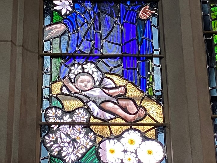 Stained glass window depicting a mother and child in a cathedral