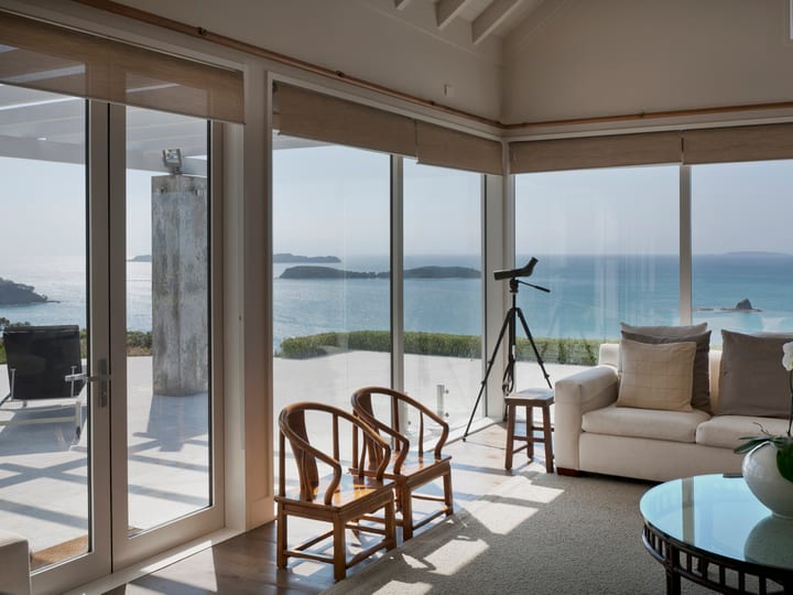 Open-plan living room with sea views through large sliding glass doors