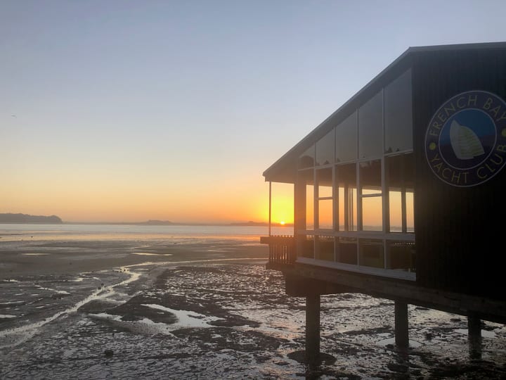 Waterfront building at sunrise with tidal flats exposed