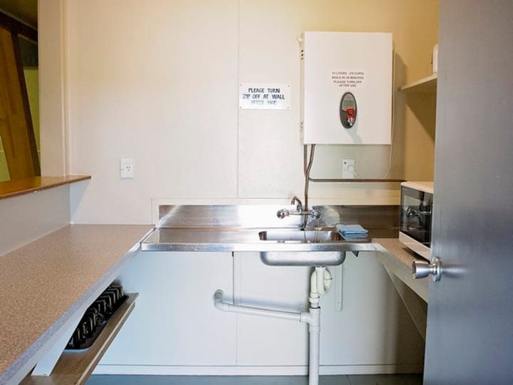 Small kitchenette with sink, counter and small appliances
