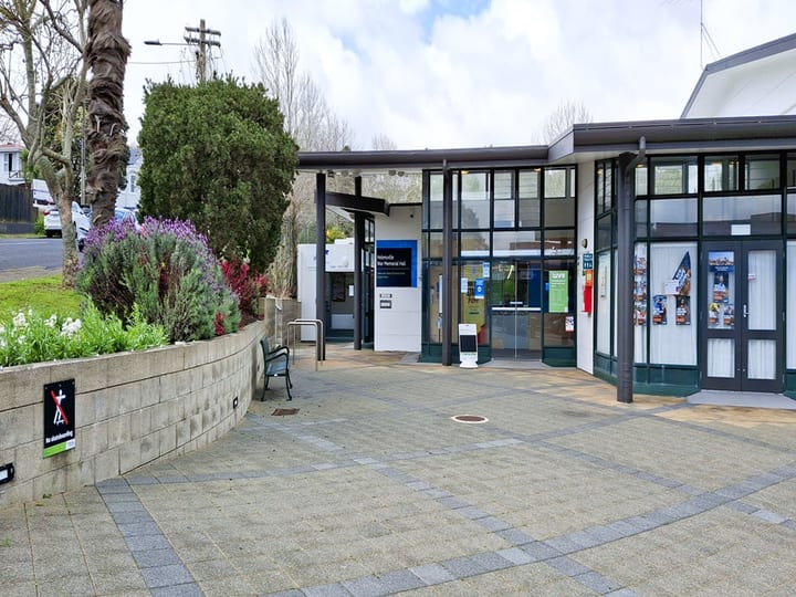 Entry forecourt with curved garden wall, bench seating and glazed entrance to community hall