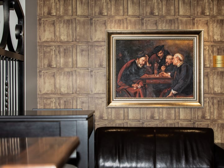 Lounge area with leather sofas, stone fireplace and wine rack in background