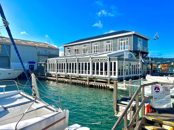 Dockside restaurant building over the water with boats moored alongside