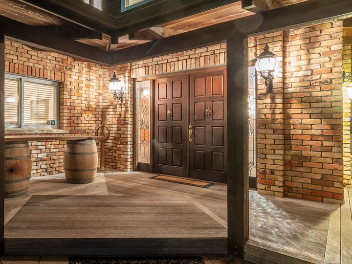 Entrance foyer with exposed brick walls, timber beams and wine barrels