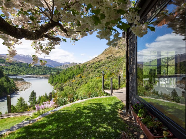 Garden terrace with a blossom tree overhanging the building and views to the river and mountains