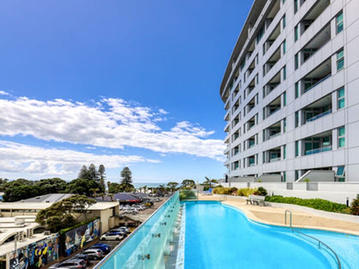 Multi-storey hotel building with pool terrace and sea view