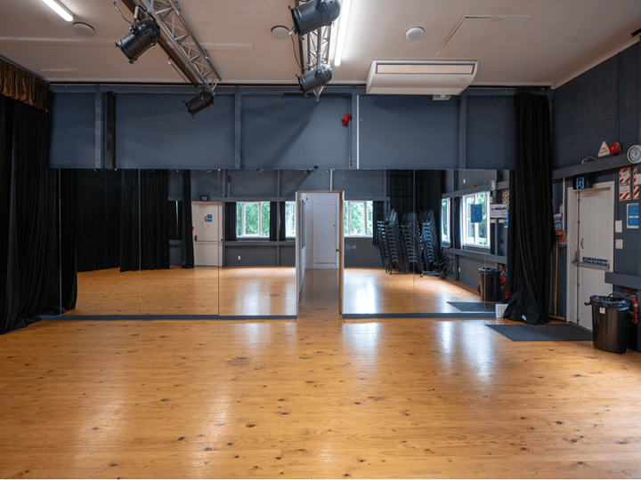 Dance studio with mirror wall, timber floor and stage lighting rig