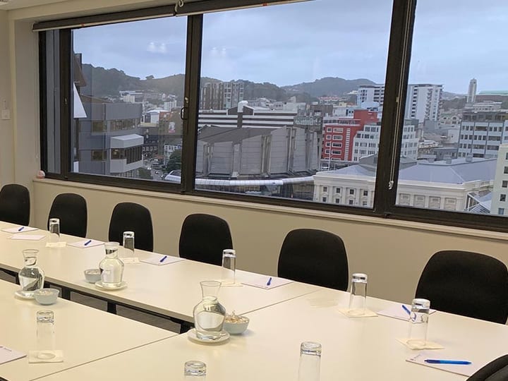 U-shaped conference room with whiteboard and city views