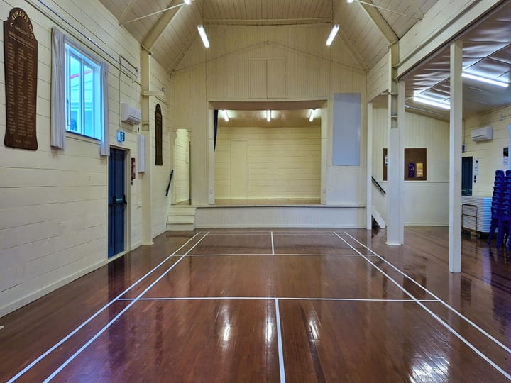 Large hall with polished floor and raised platform at far end