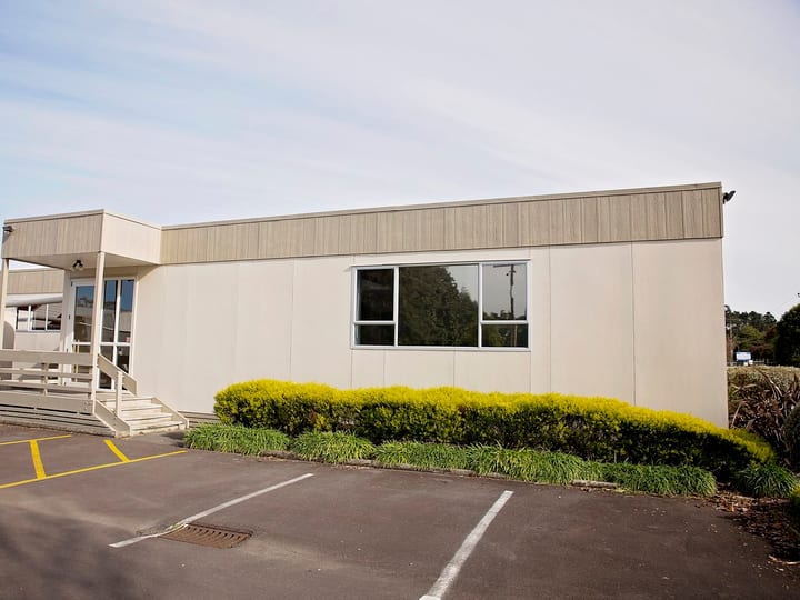 Single-storey building exterior with curved canopy entrance