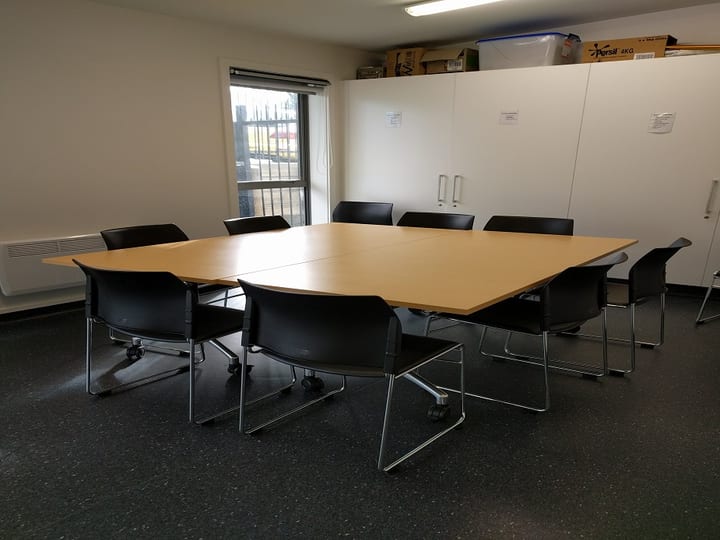 Small meeting room with square table and chairs in a circle arrangement