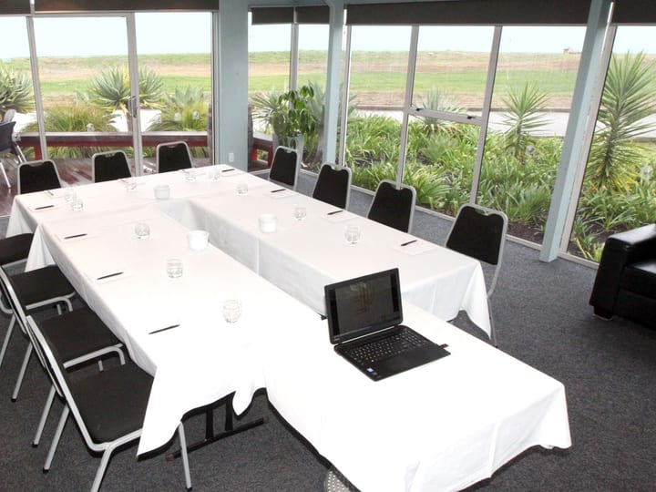 Meeting room with U-shape table and floor-to-ceiling windows to garden