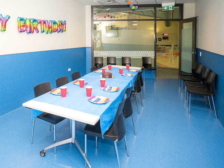 Function room set with table and chairs decorated for a birthday party