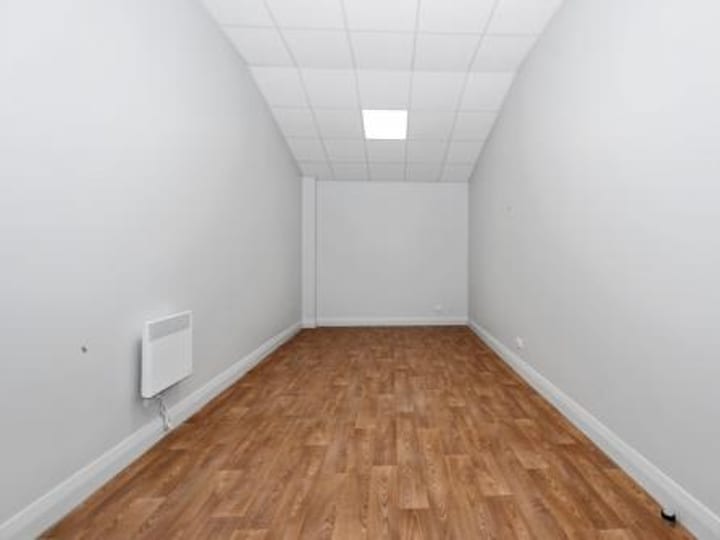 Small plain room with timber floor and white walls