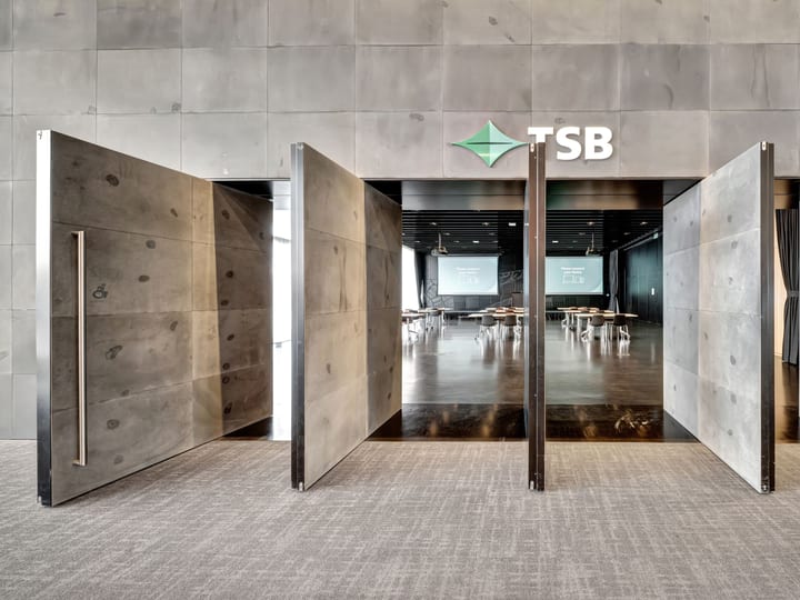 Entrance to a function room through large concrete doors with TSB signage