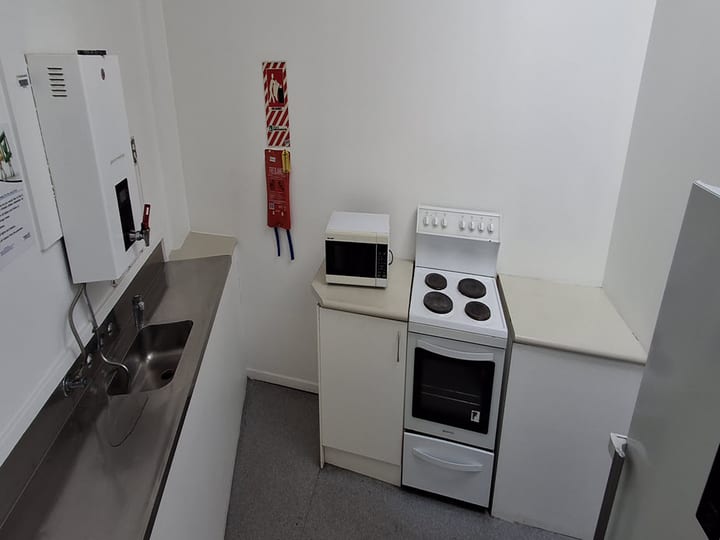Kitchen bench with stainless sink, microwave and stove