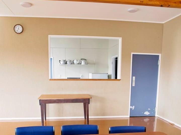 Small meeting room with table, chairs and kitchenette hatch