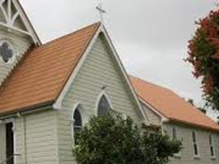 Small heritage church with arched windows and cross