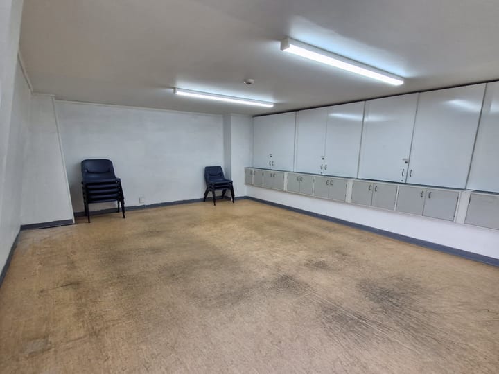 Small bare room with wall cabinets and exit door