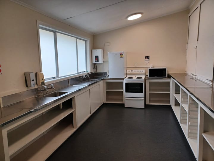 Hall kitchen with stainless steel bench, oven and appliances