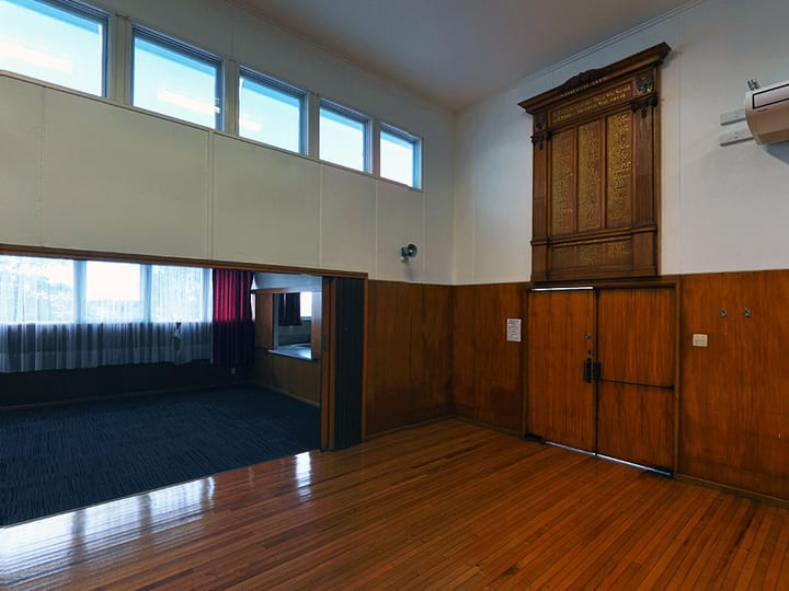Hall interior with polished wood floors, timber wainscoting and a memorial honour board