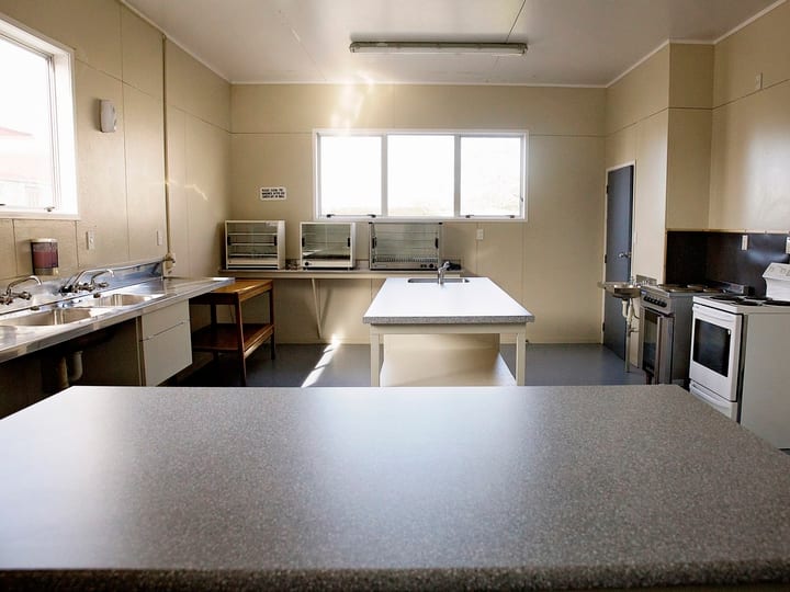 Community kitchen with benches, oven and appliances