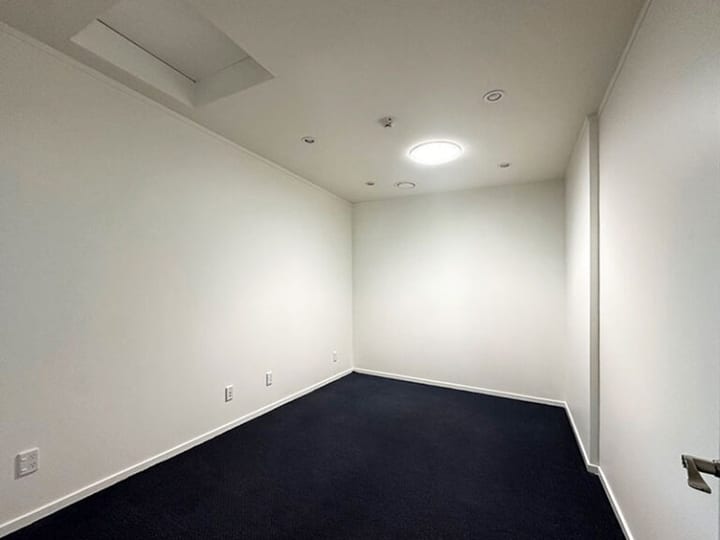 Corridor or foyer space with full-height glazed end wall overlooking street