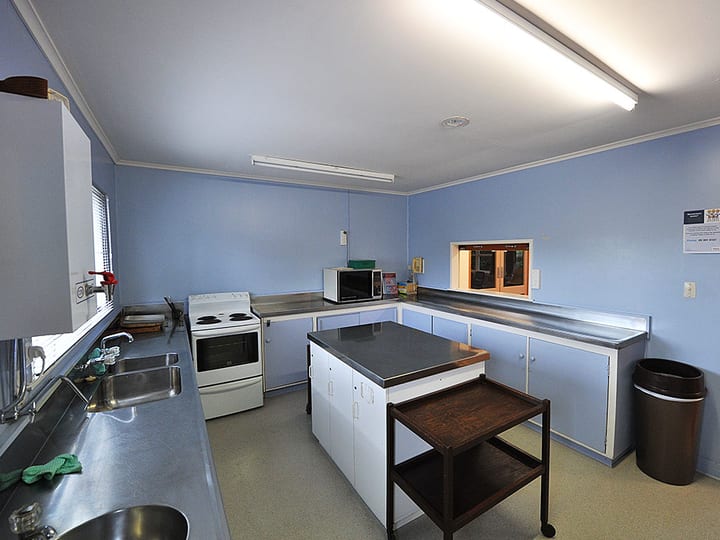 Hall kitchen from second angle showing oven, microwave and bench space