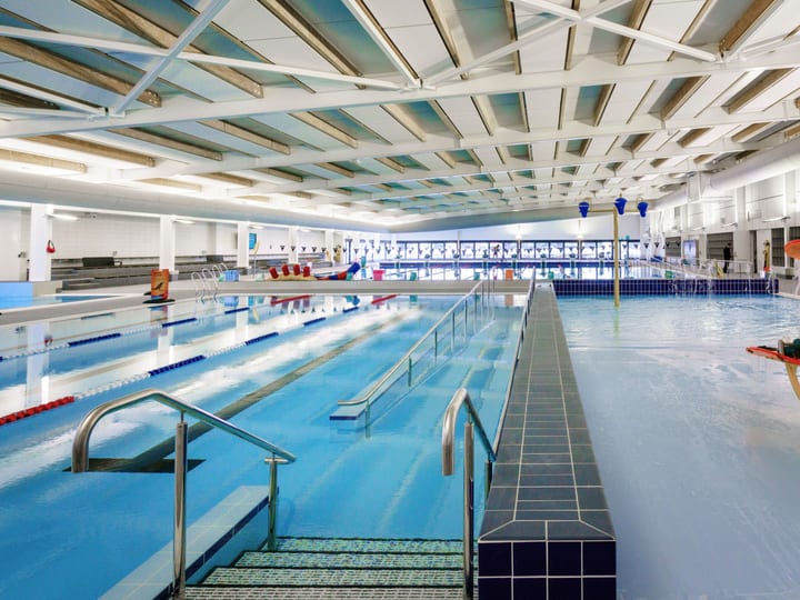 Indoor swimming pool with lane ropes and water play equipment