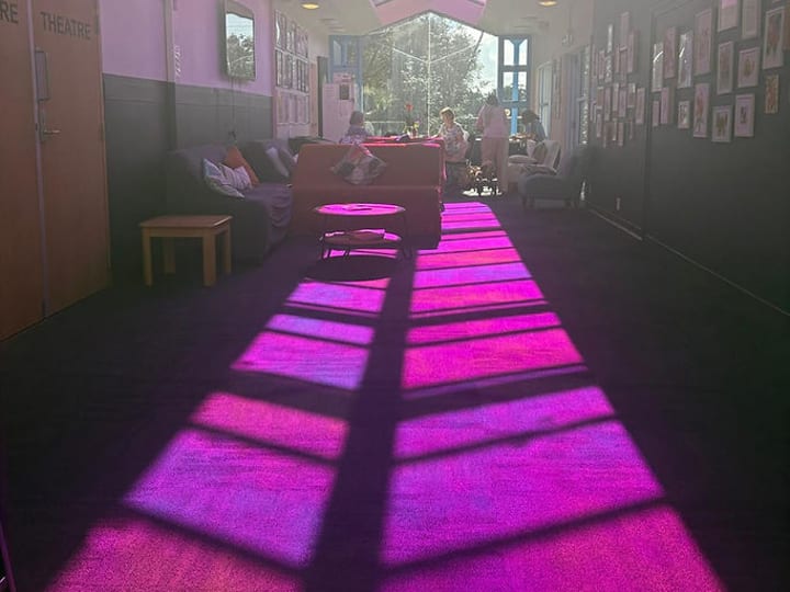 Long corridor interior with coloured light falling through skylight roof panels