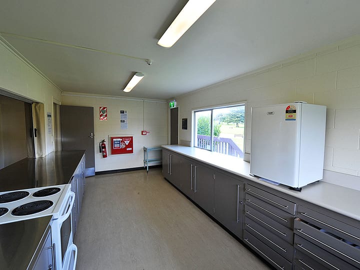 Kitchen with grey cabinetry, stove and refrigerator