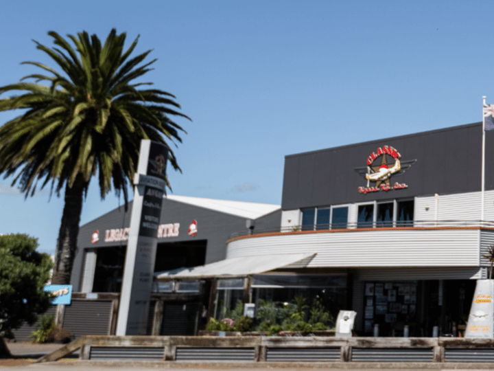 Classic Flyers NZ building exterior with cafe signage and palm trees