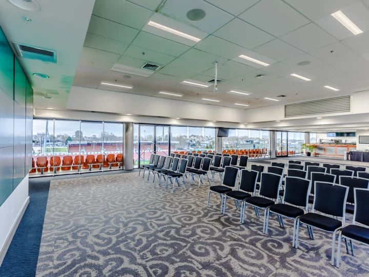 Stadium lounge with chairs in theatre layout overlooking the pitch