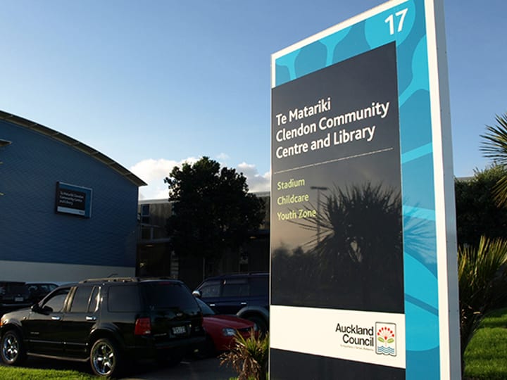 Community centre exterior with signage pylon in carpark