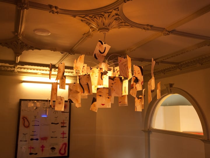 Heritage interior room with ornate plaster ceiling and hanging light installation