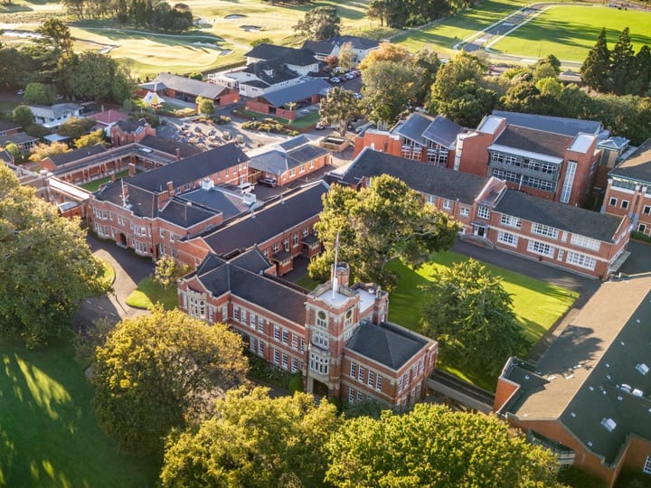 Aerial view of college campus buildings and grounds in morning light