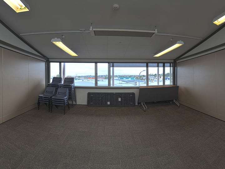Plain empty room with carpet tiles, two doors and a whiteboard