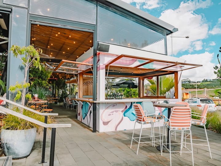 Outdoor bar and terrace area with colourful mural and seating