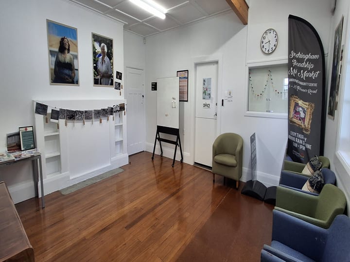 Community centre reception area with timber floors, seating and promotional banner