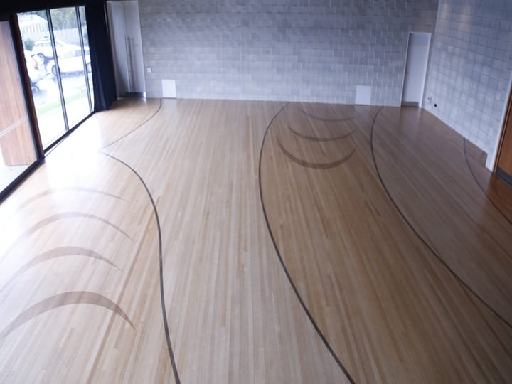 Sports court floor with curved line markings viewed from above