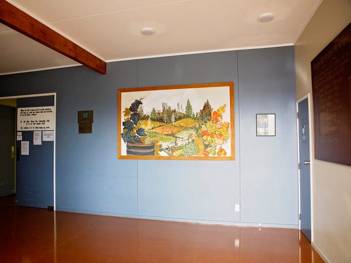 Lobby area with blue walls and framed artwork on display