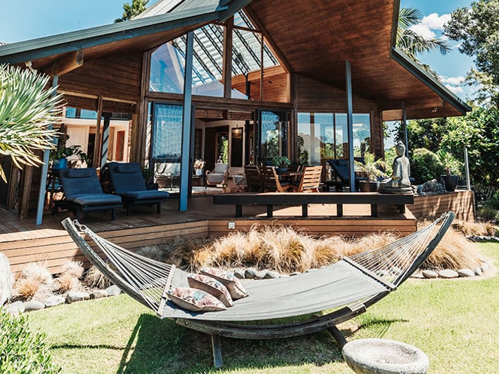 Lodge with distinctive angular timber roof, hammock and timber deck
