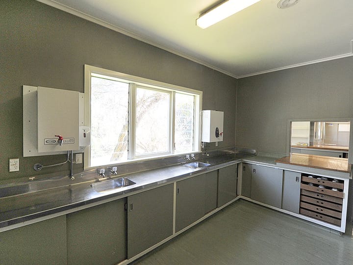 Plain kitchen with grey cabinetry and stainless steel benchtop