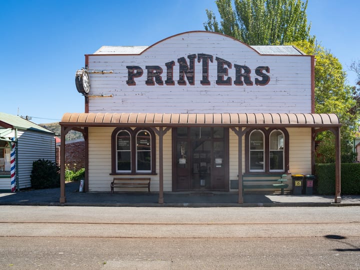 Heritage Printers building facade with broad verandah and clock