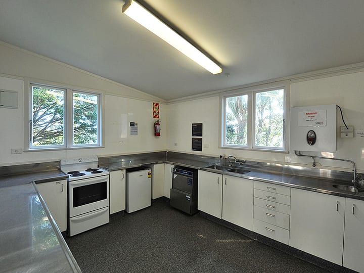 Second community kitchen view with stainless steel benches and appliances